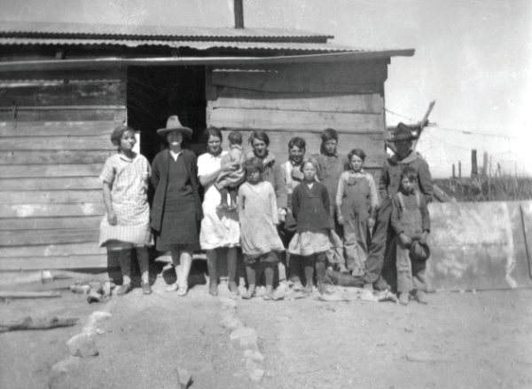 School group at the Gililland Ranch. Back row— Unknown, Miss Le wich, teacher, Alice Gililland holding Lola Gililland, Emmett Henderson, Andy Henderson, Sam Gililland, Hodges Henderson, and Frank Martin. Front row—Dixie Gililland, Bera Martin, and unknown, 1926-27.
