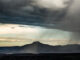 color landscape of rain in the foreground and light behind