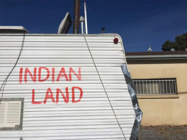 Detail of camper with handpainted lettering that says indian land