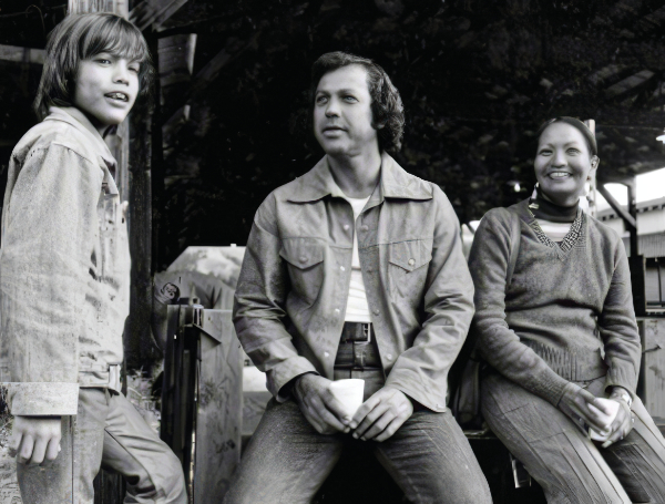 Black and white photo with a young boy, and two adults