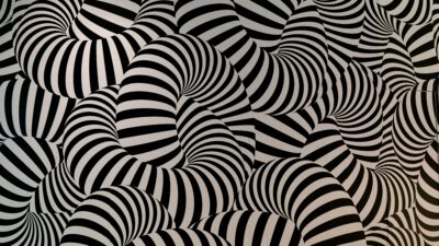 Black and white striped tubes intertwine and overlap, forming an abstract, hypnotic pattern with a sense of movement and depth. [gen-ai]