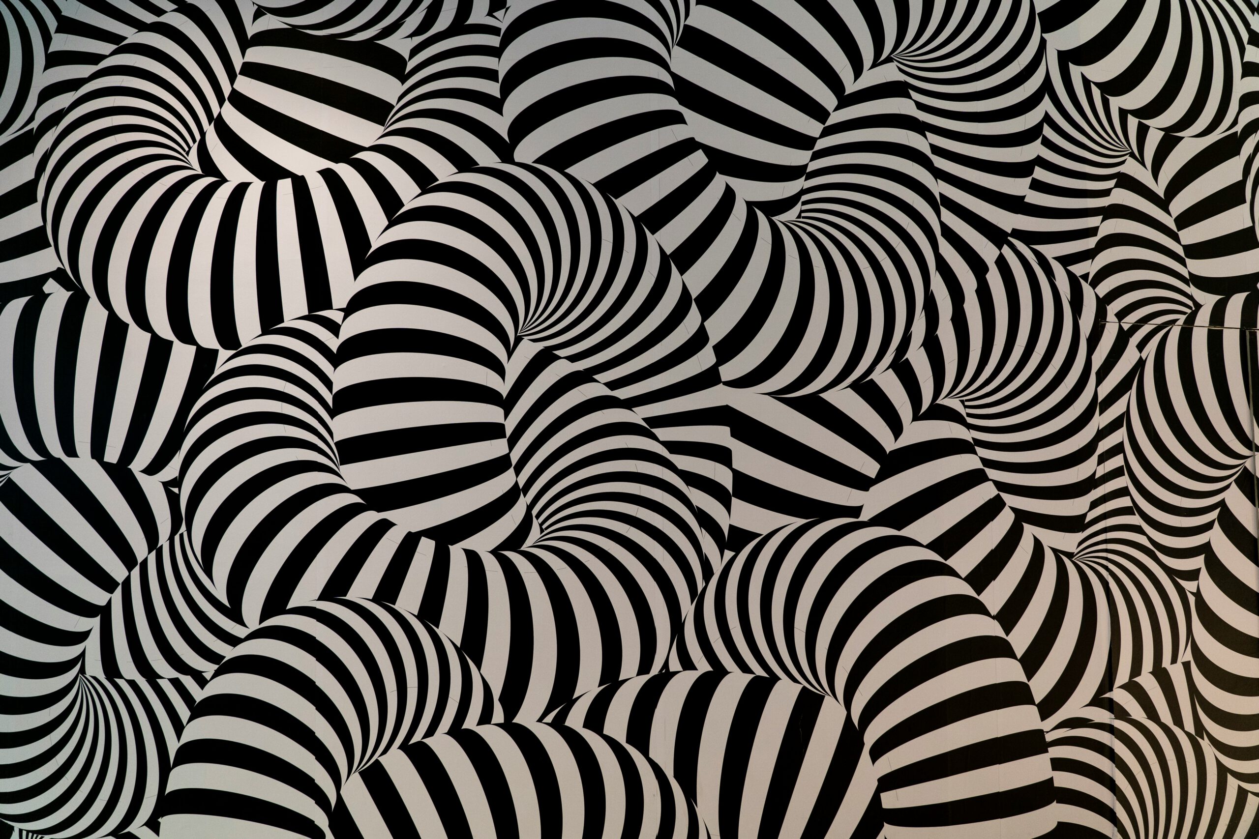Black and white striped tubes intertwine and overlap, forming an abstract, hypnotic pattern with a sense of movement and depth. [gen-ai]
