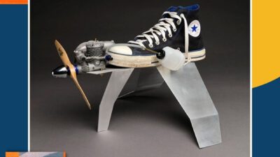 A blue Converse sneaker with an attached propeller and engine is displayed on a metallic stand. The image promotes Encounter Culture podcast, Season 3 Episode 3. [gen-ai]