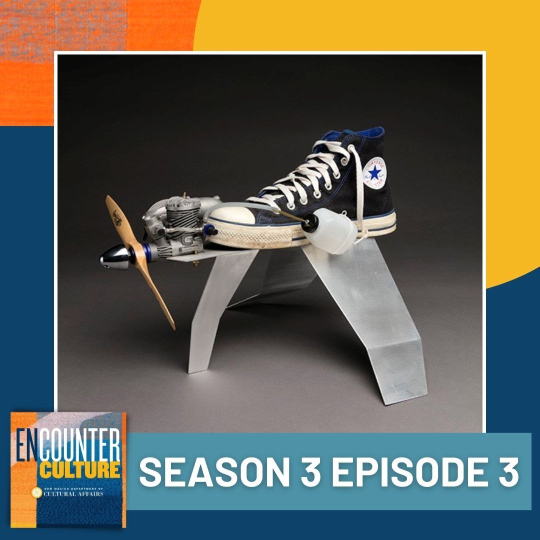 A blue Converse sneaker with an attached propeller and engine is displayed on a metallic stand. The image promotes Encounter Culture podcast, Season 3 Episode 3. [gen-ai]