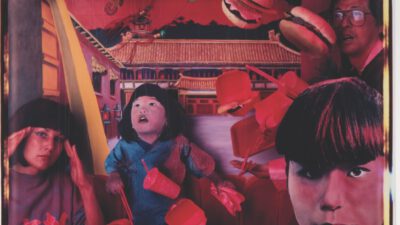 Surreal scene of people sitting at a table as fast food items float around them in a vivid, red-toned environment with a building in the background. [gen-ai]