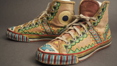 A pair of vintage Converse high-top sneakers featuring hand-painted, colorful geometric and zigzag patterns on the canvas and rubber parts. [gen-ai]