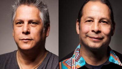 Side-by-side portraits of two men; the man on the left has gray hair and a necklace, while the man on the right has dark hair and wears a patterned shirt. [gen-ai]