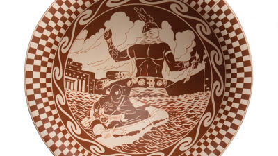 Brown and white ceramic plate with a central illustration of two Indigenous figures by water, one standing and one sitting, surrounded by a checkered and swirled border pattern. [gen-ai]