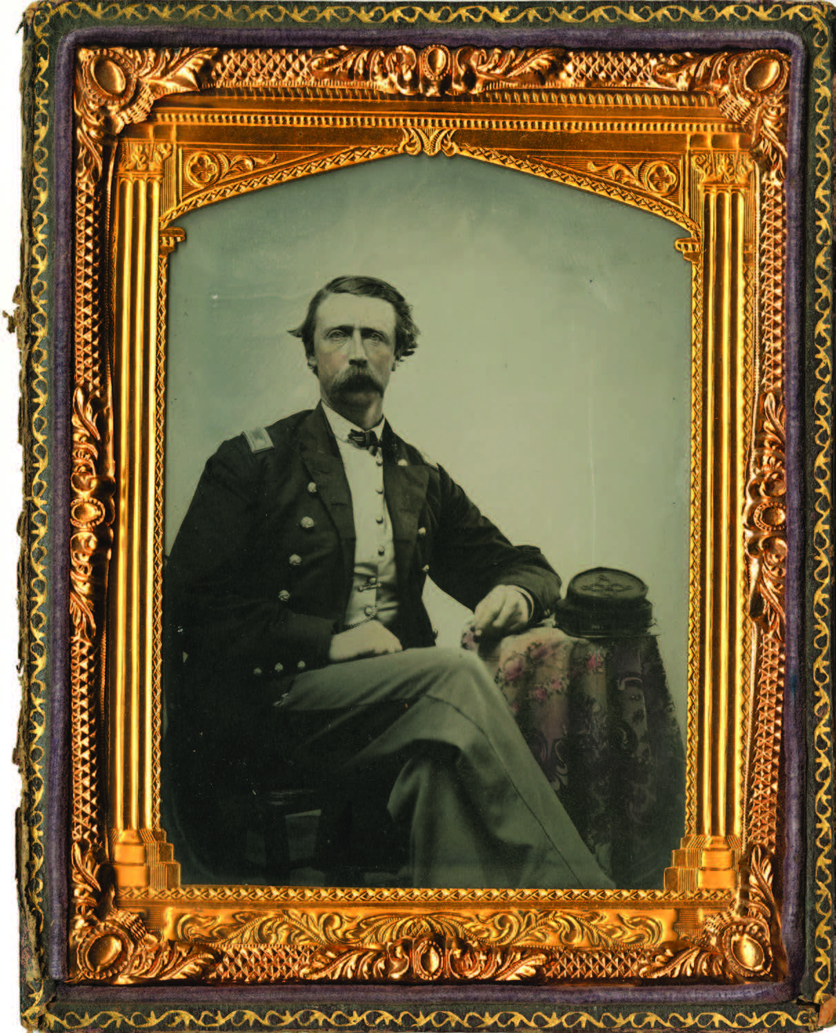 A seated man in a military uniform poses for a formal portrait, framed by an ornate gold border with detailed patterns. [gen-ai]