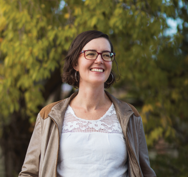 color photograph of woman with glasses smiling