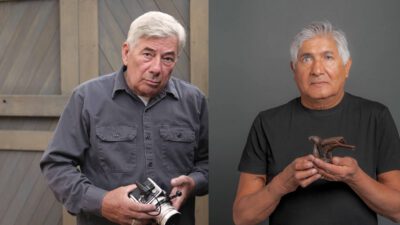 Two older men; the first wears a gray shirt and holds a camera outdoors, the second wears a black shirt and holds a small bird sculpture against a gray background. [gen-ai]