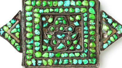 Square silver pendant with a central floral motif, decorated with turquoise and green stones, and four triangular extensions, each adorned with matching stones. [gen-ai]