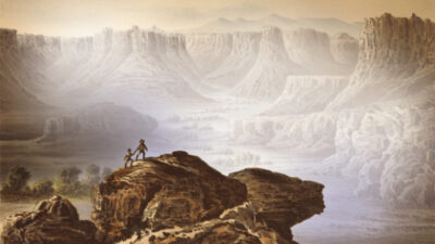Two figures stand on a rocky outcrop overlooking a vast canyon landscape with cliffs, mesas, and distant mountains under a hazy sky. [gen-ai]