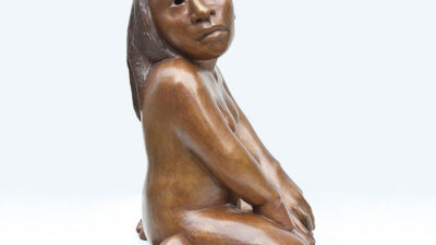 Bronze sculpture of a seated nude person with long hair, looking slightly upward, hands resting on thighs, and legs folded beneath. [gen-ai]