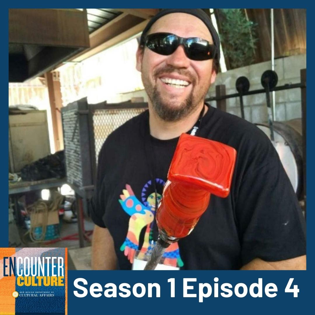 A smiling man wearing sunglasses and a black shirt holds a red glassblowing piece in a workshop. Text reads: Encounter Culture, Season 1 Episode 4. [gen-ai]