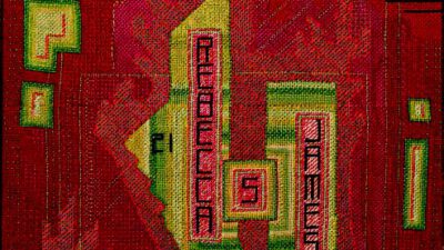 A textile artwork features abstract red, green, and pink geometric shapes with the text Rebecca James, 1950 woven into the center. [gen-ai]