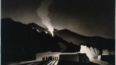 A group of people stand in front of dark mountains at night, with smoke rising from the peak and strong light casting long shadows on the ground. [gen-ai]