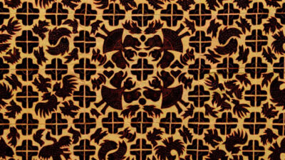 A decorative pattern featuring repeating dark dragon motifs and cross-shaped cutouts on a golden background. [gen-ai]