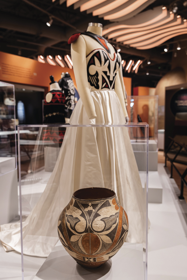 Foreground: Jar, Acoma or Laguna Pueblo, ca. 1910. Clay, crushed potsherd temper, mineral and carbon paint, slip. 12 × 11 11/16 inches. Gift of Juan Olivas. MIAC Collection: 12024/12. Background: Loren Aragon (Acoma Pueblo), Ancestral Awakening, 2019-2022. Photograph by Tira Howard.