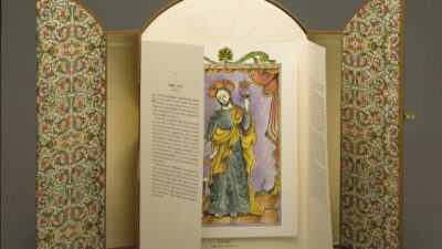 Color photograph of portfolio of fine art prints displayed vertically and open