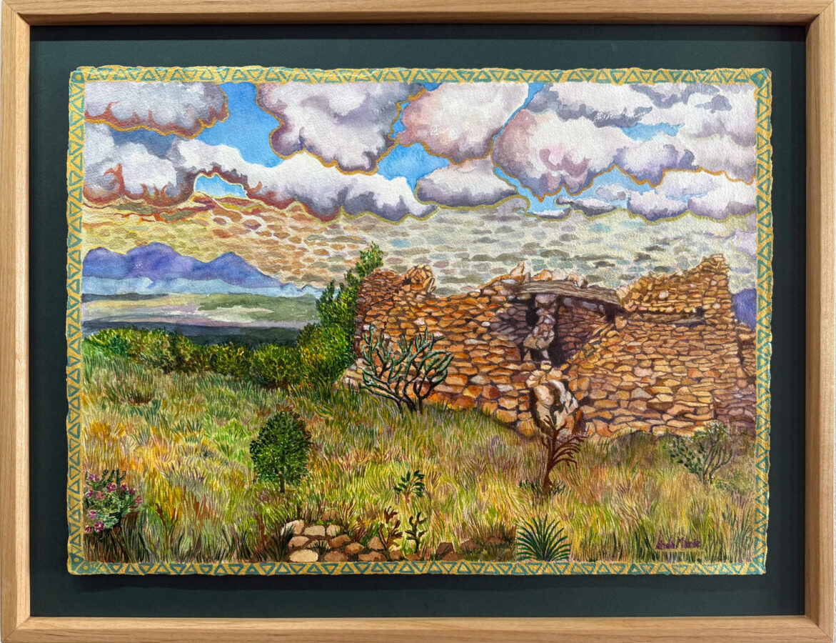A framed painting depicts an old stone ruin surrounded by grass, plants, and distant mountains under a sky with scattered clouds.