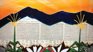 A vibrant painting shows two corn stalks and a cactus with red fruit in the foreground, a mountain range in the middle, and the U.S. Declaration of Independence text and a radiant sunrise in the background.