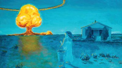 A woman carrying a bucket stands outside a house, watching a large nuclear explosion with a mushroom cloud in the distance under a blue sky.